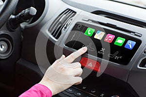 Woman in a car and touch play finger in auto smart system