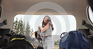 Woman, car trunk and backpack for road trip, travel or holiday with baggage, ready or preparation. Girl, transportation