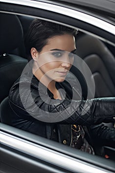 Woman, car and view while driving on a journey or adventure in a luxury vehicle. Female person, roadtrip and steering