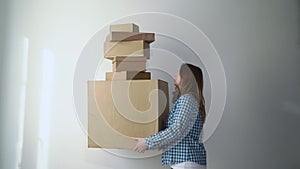 Woman with cardboard boxes, delivery girl holds and drops things.Falling storage