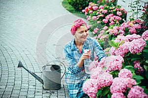 Woman care of flowers in garden. Flower care and watering. soils and fertilizers. Greenhouse flowers. happy woman