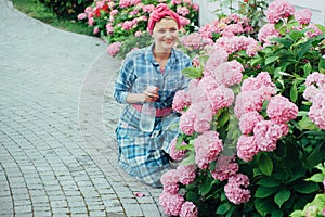 Woman care of flowers in garden. Flower care and watering. soils and fertilizers. Greenhouse flowers. happy woman