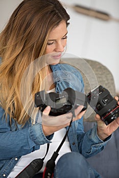 woman carefully assambling camera lens