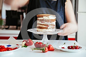 Woman Carefully Icing The Cake