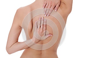 Woman caressing her bare shoulder and back