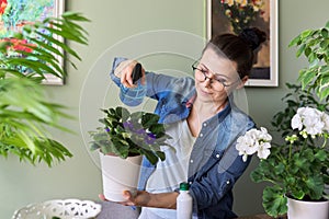 Woman caring for indoor plants, hobbies and leisure, nature in the house