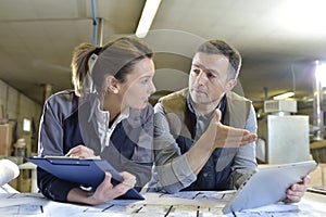 Woman and carpentry instructor using tablet