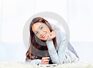 Woman on carpet taking notes