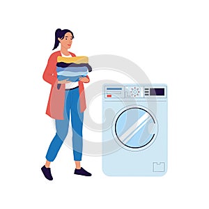 Woman carries things to washing machine. Female holding clean garment stack. Laundry equipment. Housewife loading