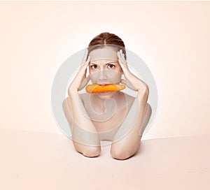 Woman with carrot in mouth