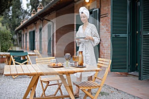 Woman carry food to table for breakfast at morning