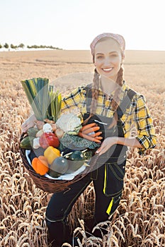 Woman carrying basket with healthy and locally produced vegetables