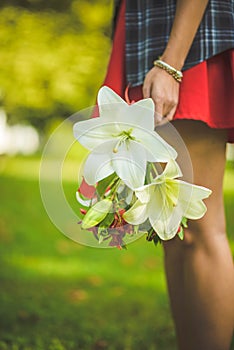 Woman carrying a bouquet of flowers