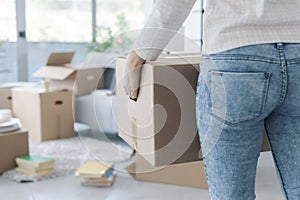 Woman carrying boxes in her new apartment