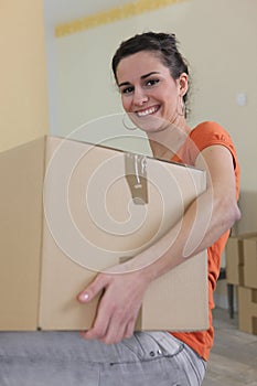 Woman carrying a cardboard box