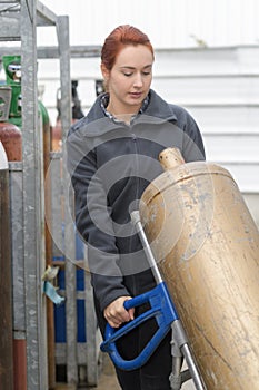 Woman carrying gas bottle