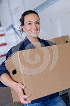 woman carrying large box in workplace