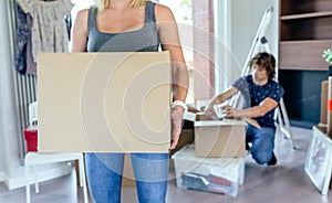 Woman carrying moving box