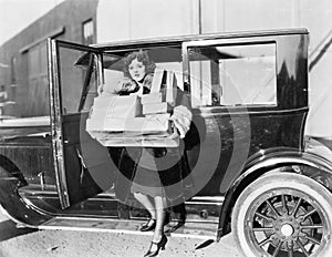 Woman carrying packages from car