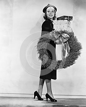 Woman carrying packages and Christmas wreath