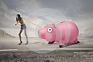 Woman carrying a piggy bank