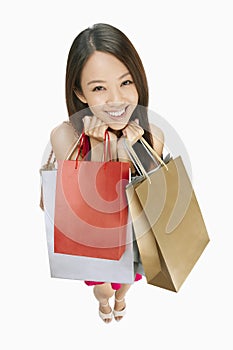 Woman carrying shopping bags. Conceptual image