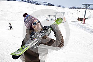 Woman carrying skis