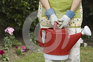 Woman Carrying Watering Can