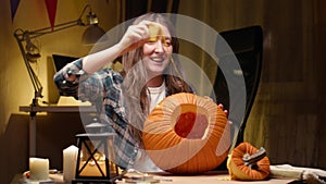 Woman carving Jack O Lantern pumpkin for Halloween