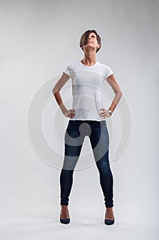 Strength personified in upward-looking woman's assertive stance photo