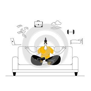 A woman in casual clothes meditates on the couch and looks for a balance between work and rest.