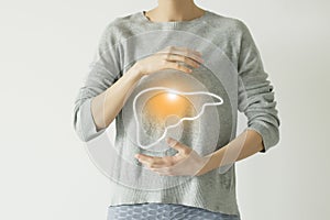 Woman in casual clothes suffering from indigestion pain, highlighted  visualisation of liver