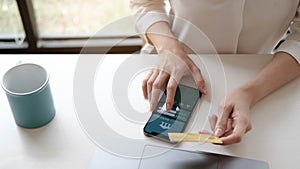 Woman in casual shirt paying with credit card online while making orders via the Internet. Successful black businesswoman making