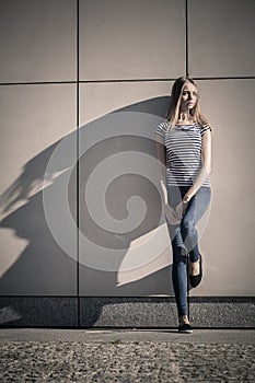 Woman casual style against stone grunge wall