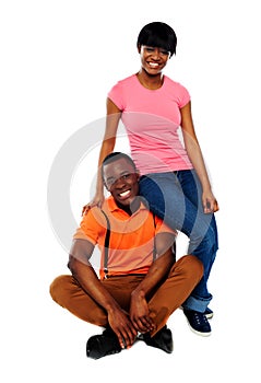 Woman in casuals sitting on mans shoulder