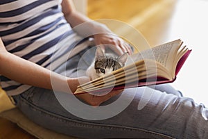 Woman and a cat reading a book