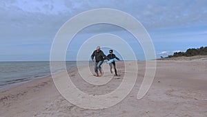 Woman catch man on the beach.Happy couple