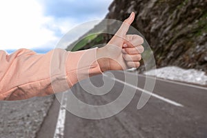 Woman catching car on road, closeup. Hitchhiking trip