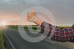 Woman catching car on road, closeup. Hitchhiking trip