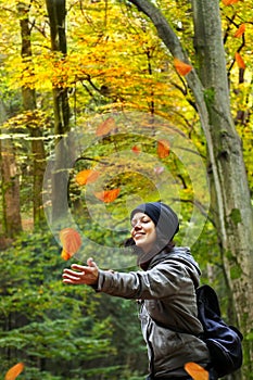 Woman is catching falling leaves