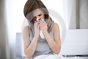 Woman caught cold. sneezing into tissue