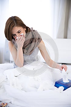 Woman caught cold. sneezing into tissue