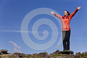 Woman Celebrating Achievement on Top Of A Mountain