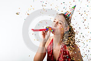 Woman celebrating birthday with streamer and party hat