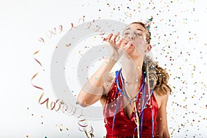 Woman celebrating birthday with streamer and party hat