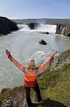 Woman Celebrating At Godafoss Waterfall, Iceland