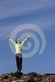 Woman Celebrating On Top Of A Mountain