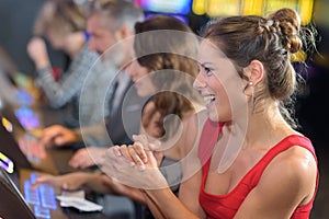 Woman celebrating win on slot machine at casino