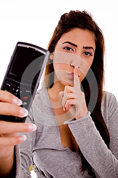 Woman with cell phone instructing to be silent photo