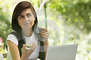 Woman with cell phone and laptop